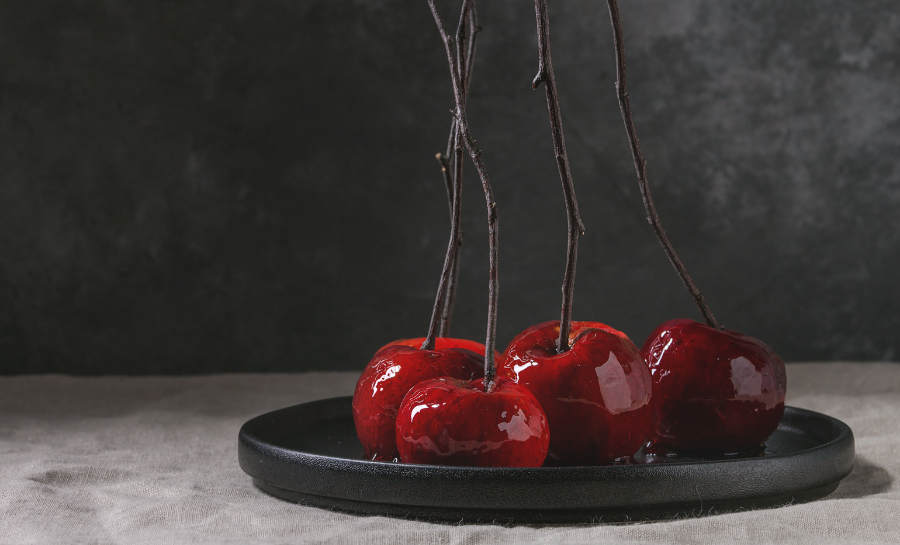 halloween-themed red wine caramel apples