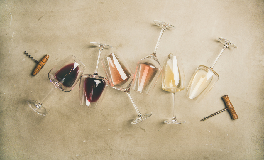 wine glasses laying on their sides with ombre dark red wine to white going left to right