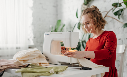 Woman sewing fabric together