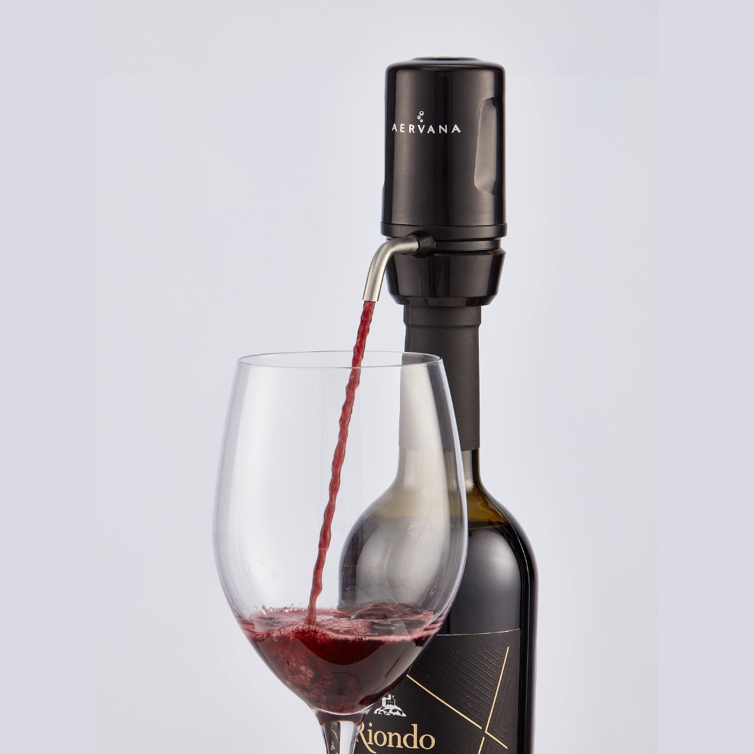 Black Aervana Travel wine aerator aerating red wine into a wine glass