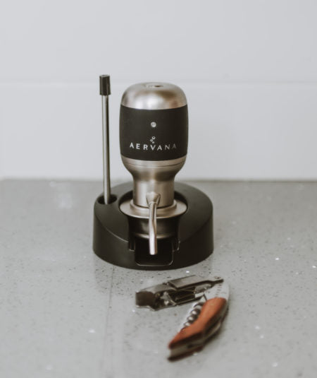 Original Wine Aerator in its stand next to branded corkscrew